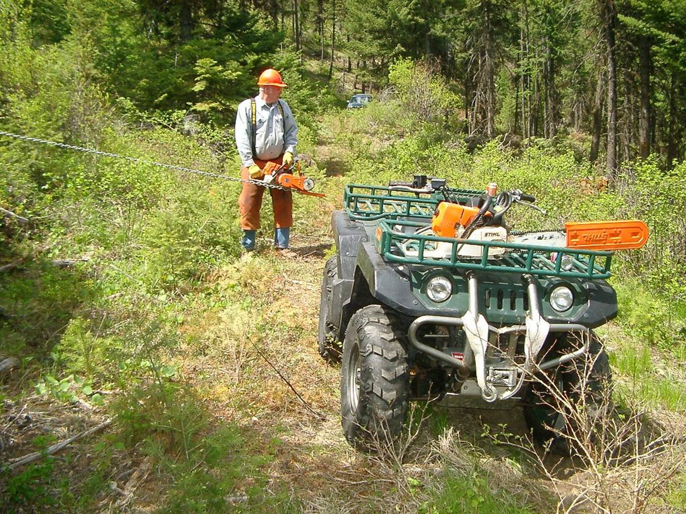 trailer winch site Lewis Winch loads logging trailer.