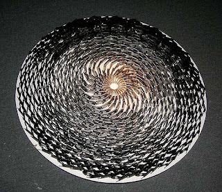 Fotografía de una escultura en forma de espiral hecha con cientos de móviles