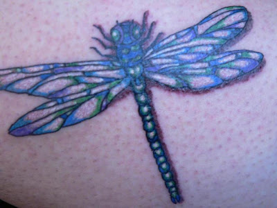 Beautiful blue dragonfly tattoo.