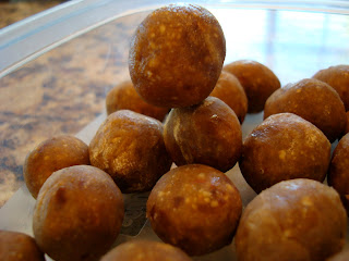 Stacked Vegan Peanut Butter Vanilla Balls thawing out on countertop