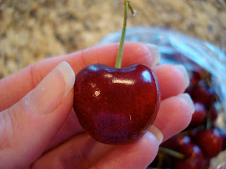 Close up of hand holding cherry