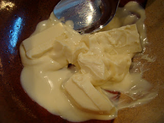 Spoon stirring semi-melted white chocolate
