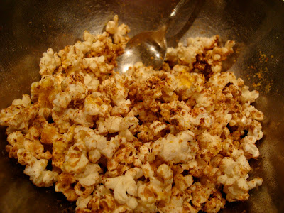 Coconut Oil & Maca Popcorn in bowl being stirred up