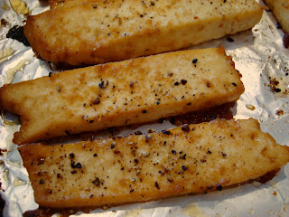 Three pieces of Sesame Ginger Maple Tofu on pan
