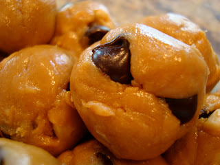 Close up of one No-Bake Vegan Peanut Butter Chocolate Chip Cookie Dough Balls