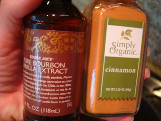 Bottle of vanilla extract and container of cinnamon