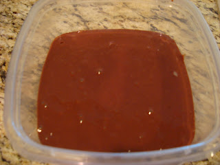 Chocolate coconut milk mixture in clear container