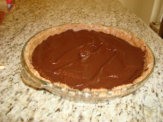 Raw Vegan Chocolate Pie in clear pie plate on countertop