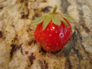 Fresh strawberry laying on countertop