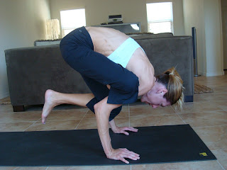 Woman doing Eka Pada Bakasna yoga pose