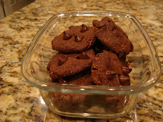 Finished Raw Vegan Chocolate Chocolate-Chip Cookies stacked in clear container