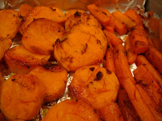 Close up of Roasted Sweet Potatoes and Carrots in foil lined pan with glaze
