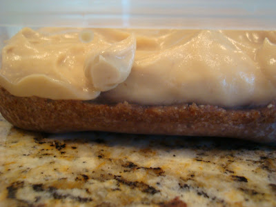 Side of container showing crust and cheesecake filling