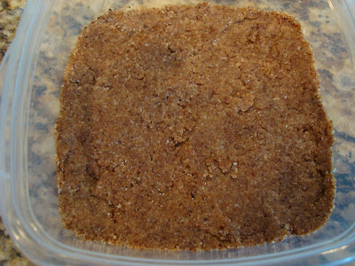 Date mixture pressed into clear container forming a crust for cheesecake