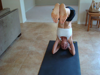 Woman doing Ardha Sirasana yoga pose