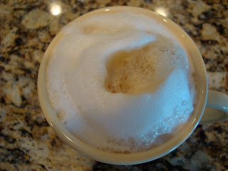 Steamed almond milk latte in mug