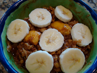 Banana-Mango Oats in bowl topped with sliced banana 