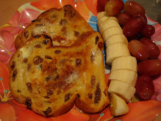 Sliced bananas and grapes with toasted bread on plate