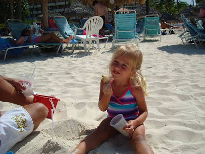 Young girl on beach building a sand castle