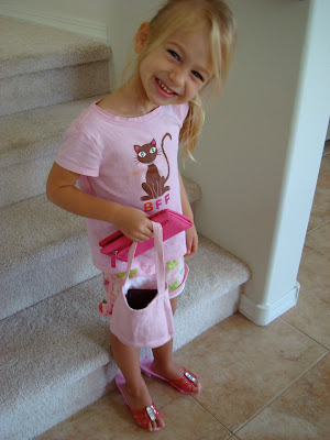 Young girl wearing pink high heels holding purse