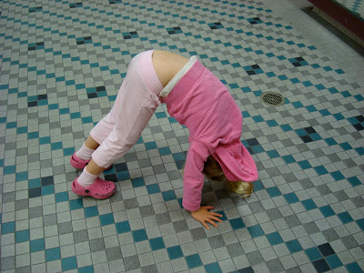Young girl doing yoga pose on floor