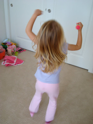 Young girl dancing with arms up in the air