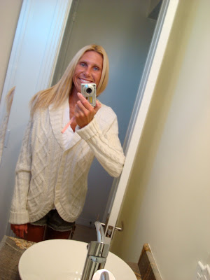 Woman wearing cozy sweater in bathroom