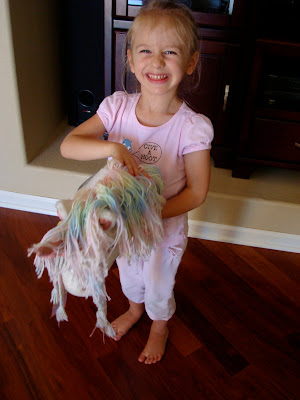 Young girl playing with a pony on a stick