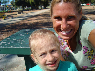 Close up of woman and child siting at picnic table smiling