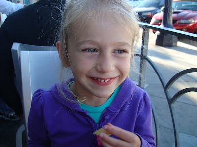 Young girl sitting eating a chip