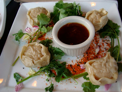 Plate full of Steamed Potstickers with dipping sauce