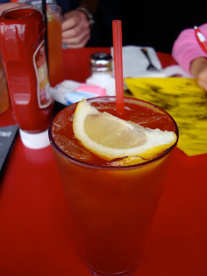 Sweet Tea Vodka with red straw and lemon wedge