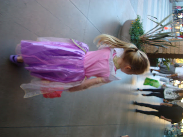 Young girl walking around mall in costume looking around