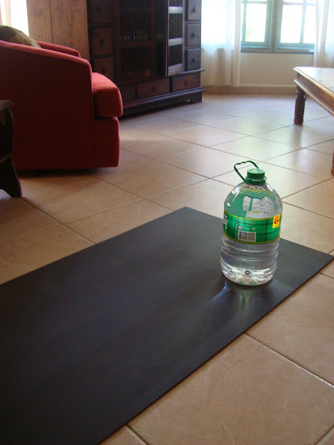 Jug of water on black yoga mat