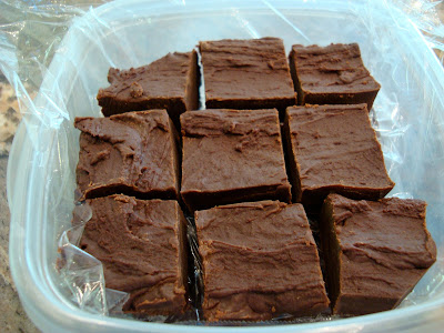 Sliced up Chocolate Peanut Butter Fudge in clear container