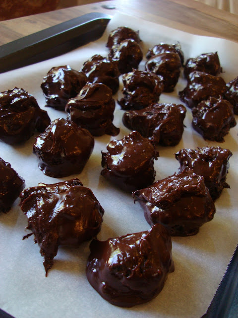 Chocolate Covered Oreo Balls on parchment lined tray to set up