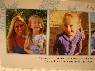Woman with young girl sitting on her lap and photo of young girl in center on christmas card