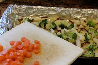 Carrots being added to baking pan