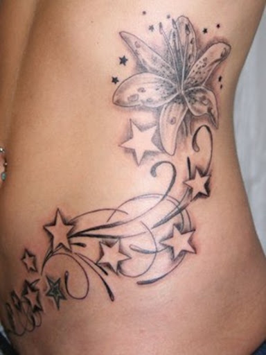back tattoo with pink and black combination color with tribal flower on