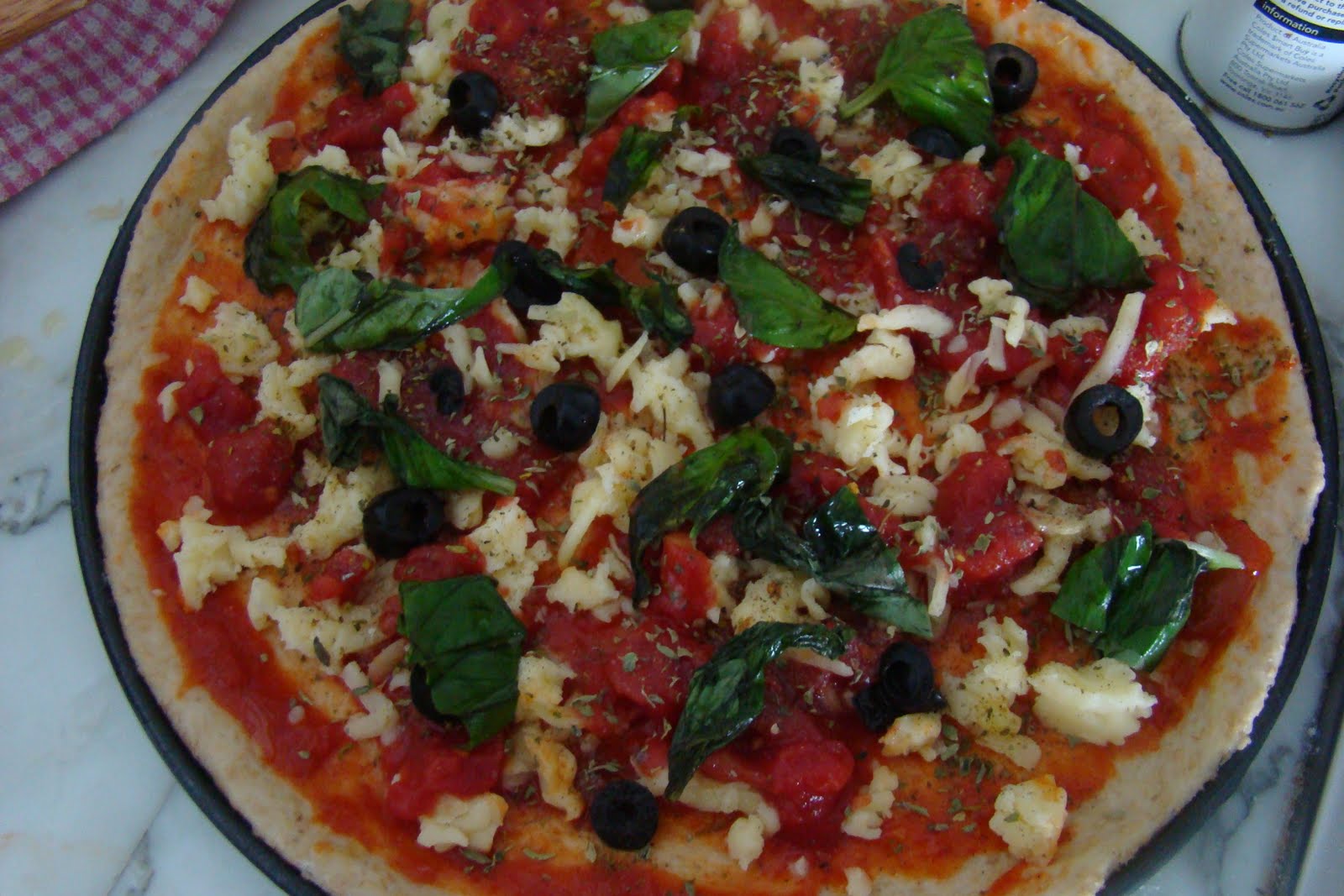 palate corner thin crust margherita pizza with olives and fresh basil