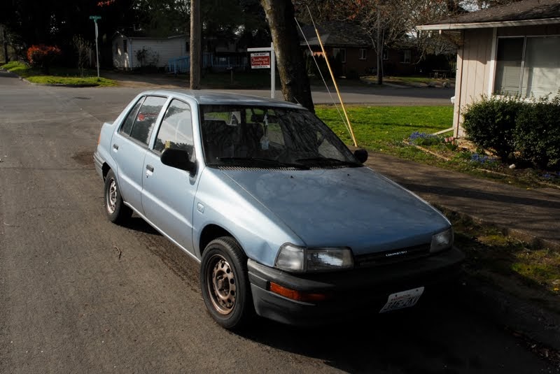 OLD PARKED CARS.: 1992 Daihatsu Charade SE Sedan.