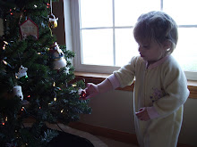 Payton hanging an ornament on the tree