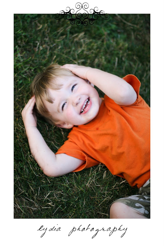 Little boy laughing on the grass at lifestyle kids portraits on a farm in Indiana, Pennsylvania