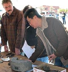 Photo of Gentleman explaining the use of grinding stone