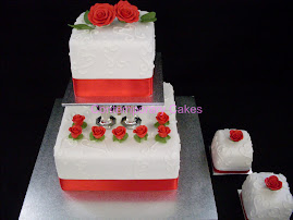 2 tier pilared square cake with red sugar roses.