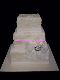 Vintage lace design 3 tier stacked cake with sugar paste bow.