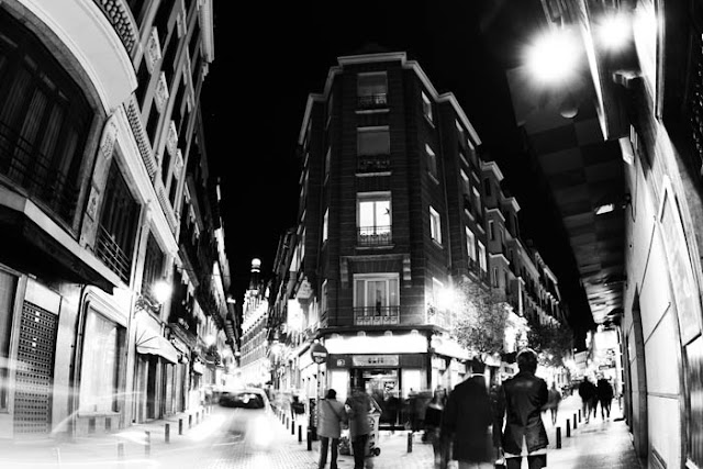 Moving people and cars on a Saturday night in Madrid, Spain.