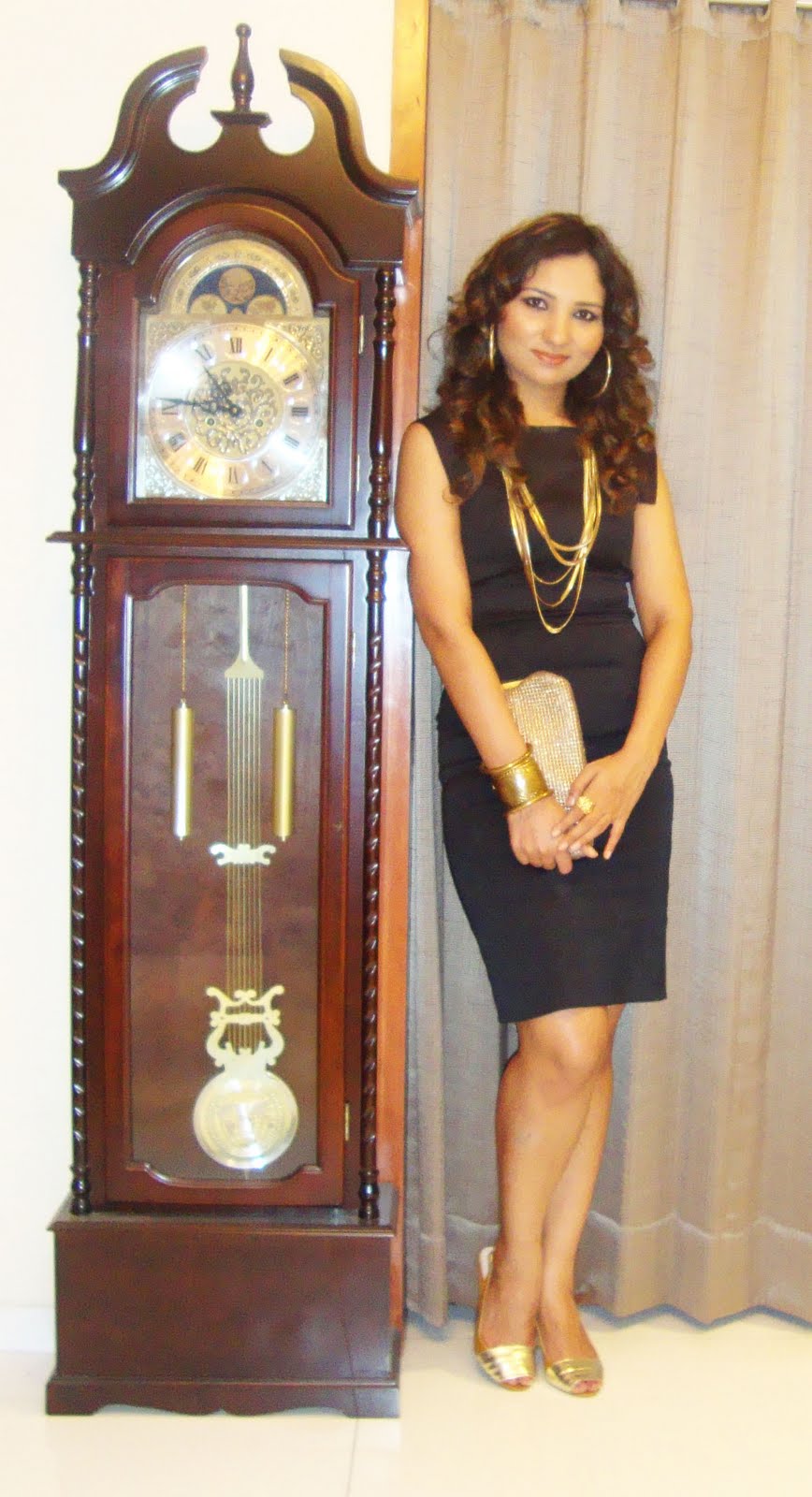 Vogue Vibes Black Dress,Gold Accessories & A Big Wall Clock...