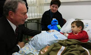 New York City Mayor Michael Bloomberg speaks to a hospitalized Israeli boy