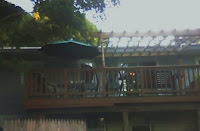 Jim's balcony deck refuge, under the green umbrella